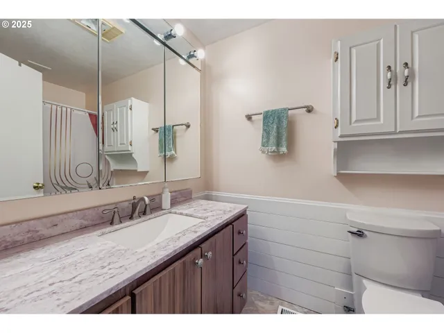 a bathroom with a granite countertop sink mirror and double