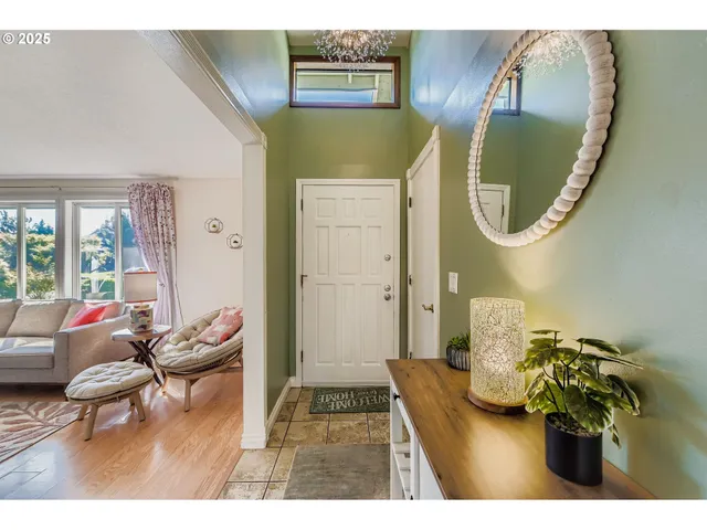 a living room with furniture and a mirror