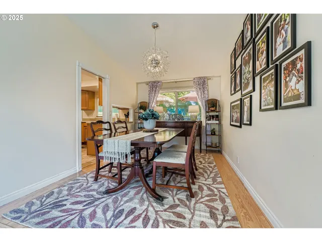 a view of a dining room with furniture and a window