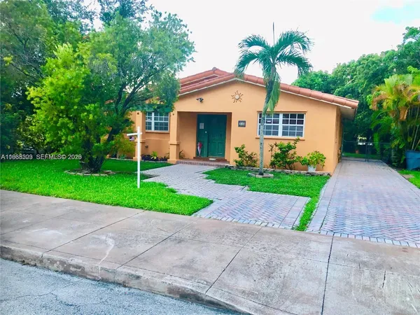 a front view of house with yard and green space