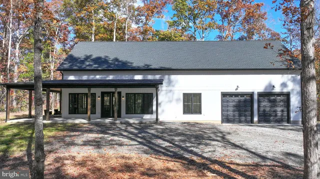 a view of a house with porch and furniture