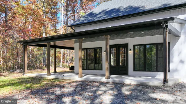 a living room with furniture a large window and a fireplace