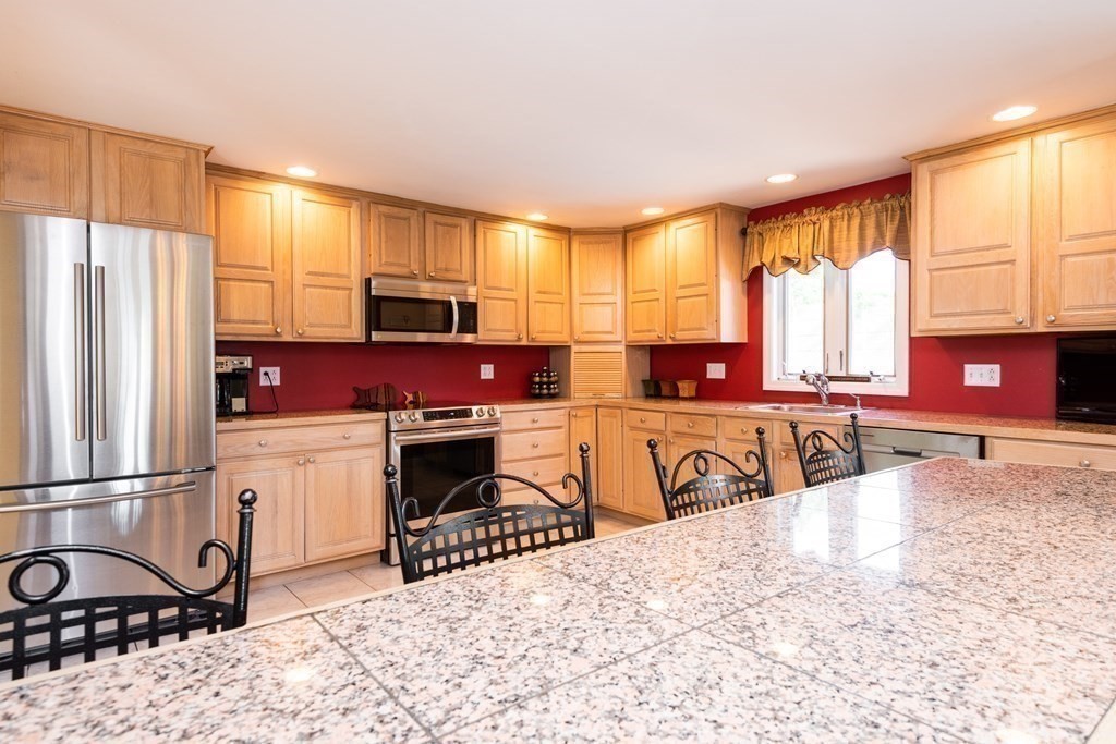 8 Pyburn Road Lynnfield, MA 01940 - Photo 19 of 35 a kitchen with stainless steel appliances granite countertop a stove a sink and a refrigerator