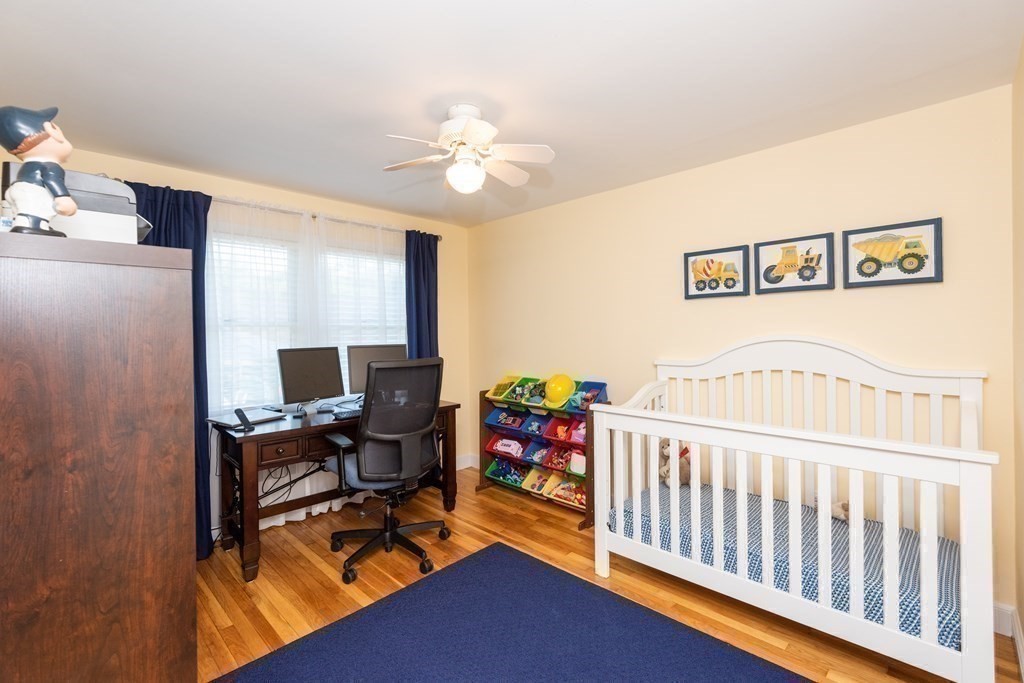 8 Pyburn Road Lynnfield, MA 01940 - Photo 25 of 35 a bedroom with a bed and a chandelier