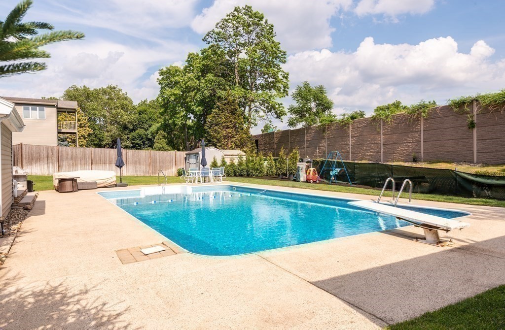 8 Pyburn Road Lynnfield, MA 01940 - Photo 27 of 35 a view of a swimming pool with a lounge chair