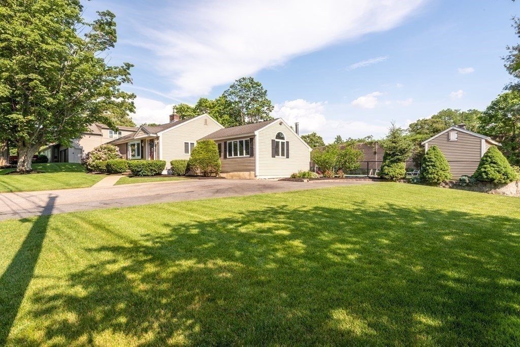 8 Pyburn Road Lynnfield, MA 01940 - Photo 5 of 35 a front view of a house with a yard and trees