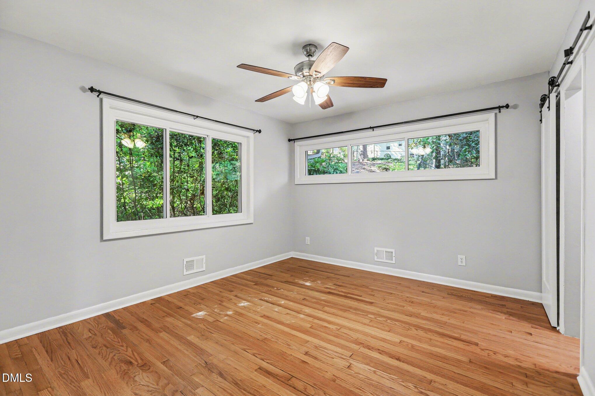 2600 Wade Avenue Raleigh, NC 27607 - Photo 13 of 31 a view of an empty room with wooden floor and a window