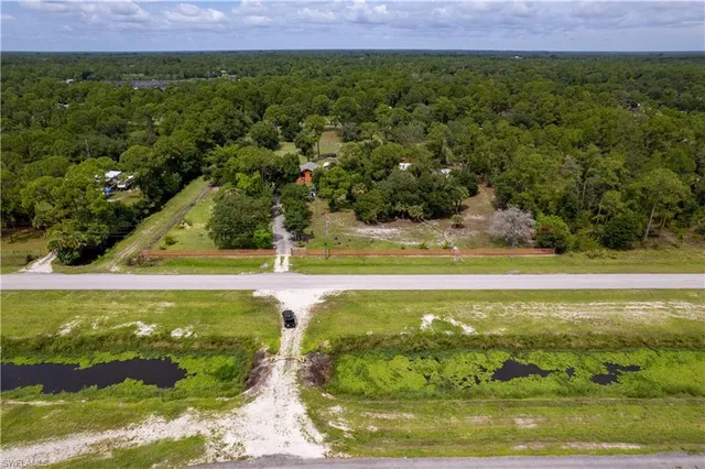 a view of a house with backyard sitting area and garden