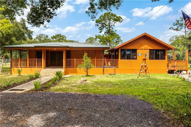 a front view of house with yard and green space