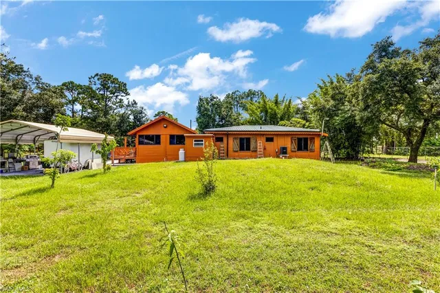 an aerial view of residential house with outdoor space and swimming pool