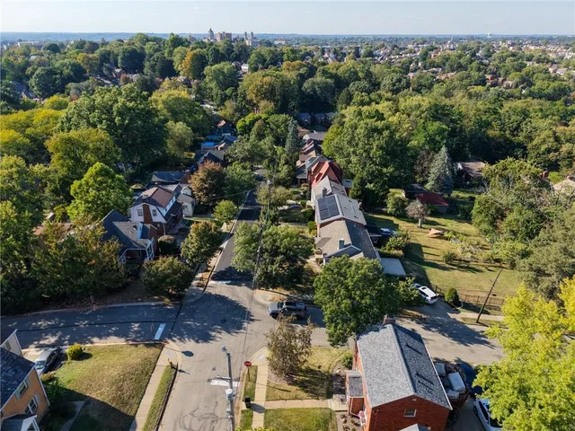 an aerial view of a house with a yard