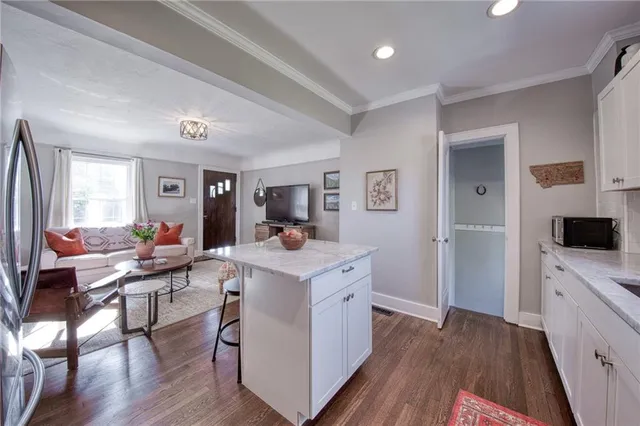 a room with a sink a window and a view of living room