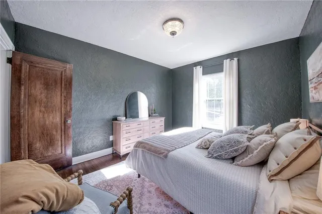 a bedroom with a bed and a mirror