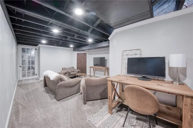 a bedroom with furniture and a flat screen tv