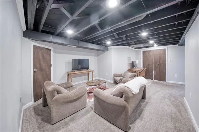 a living room with furniture and a glass door