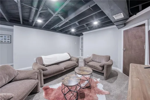 a living room with furniture and a glass door