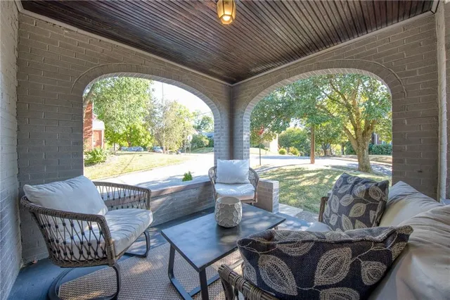 a dining room with furniture wooden floor and a potted plant