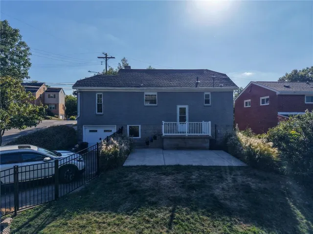 a view of a big house with a yard and plants