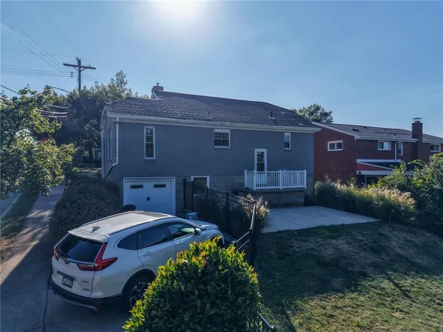 a aerial view of a house with backyard and sitting area