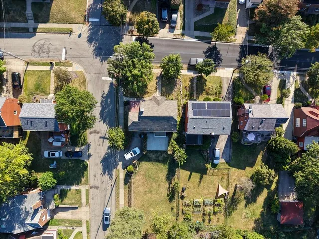 a aerial view of a houses with yard