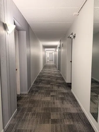 a view of a hallway with wooden floor