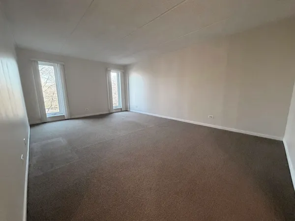 a view of an empty room and a window