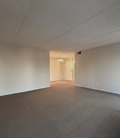 a view of an empty room and a window