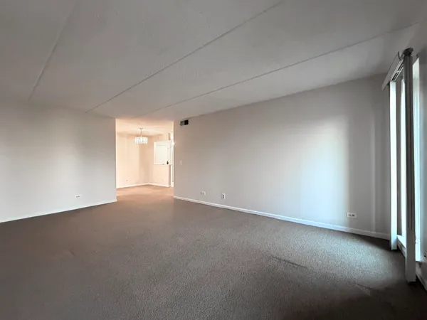 a bedroom with a bed couch and a large window