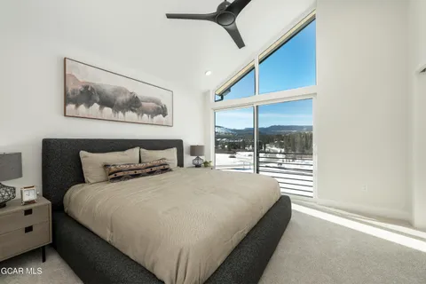 a bedroom with a bed and a painting on the wall