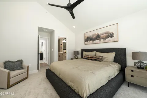 a spacious bedroom with a bed and a couch