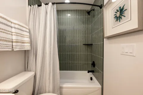 a bathroom with a shower and a toilet