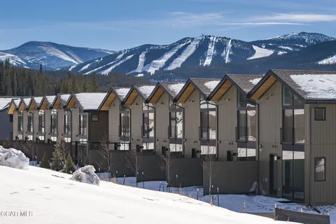 a view of a house with a swimming pool and a yard