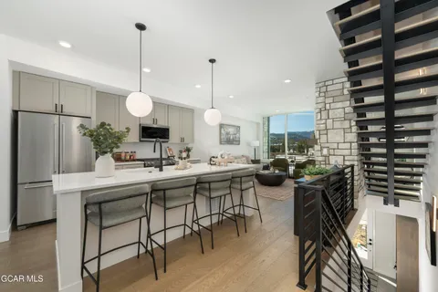 a kitchen with a table chairs stove and cabinets
