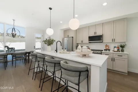 a kitchen with center island table and chairs in it