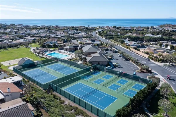 an aerial view of a tennis ground and a houses