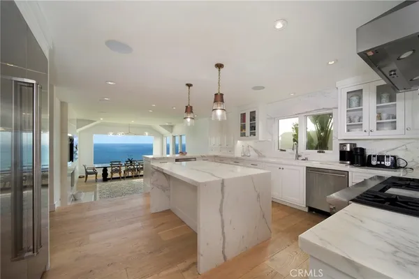 a kitchen with a sink and chairs