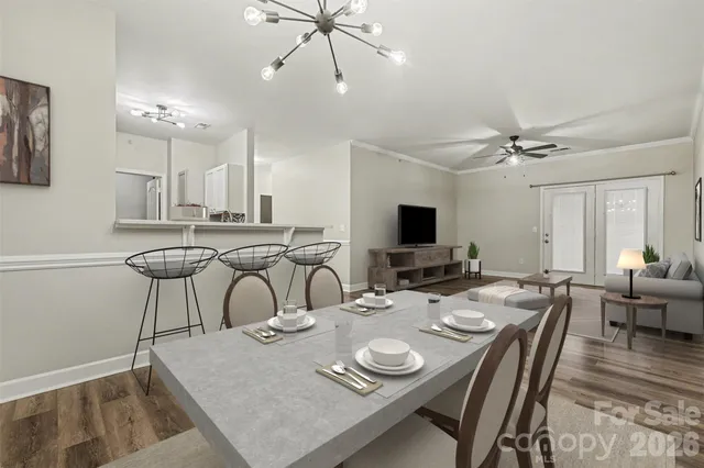 a view of a dining room with furniture and a flat screen tv