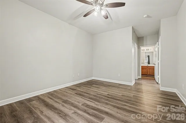 a view of an empty room and wooden floor