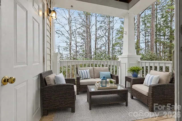 a balcony with furniture and large windows