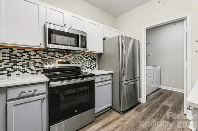 a kitchen with granite countertop wooden cabinets and stainless steel appliances