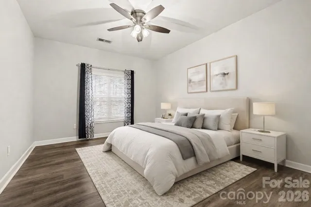 a bedroom with a large bed and a chandelier