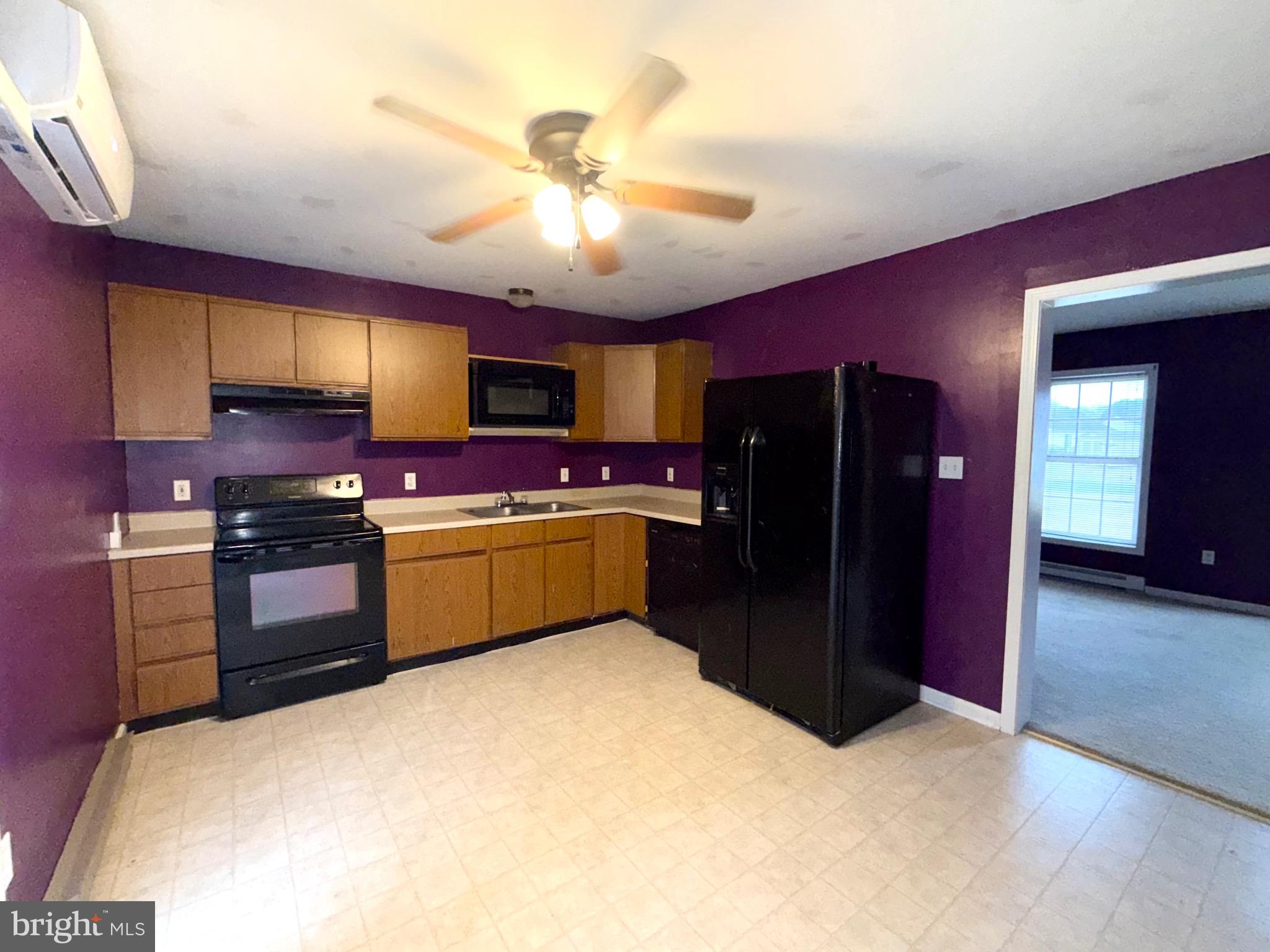 11955 Robyn Lane Princess Anne, MD 21853 - Photo 5 of 12 a kitchen with stainless steel appliances kitchen island granite countertop a refrigerator and a stove top oven