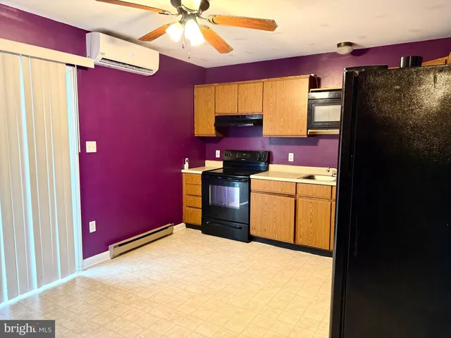 a kitchen with stainless steel appliances a refrigerator sink and stove