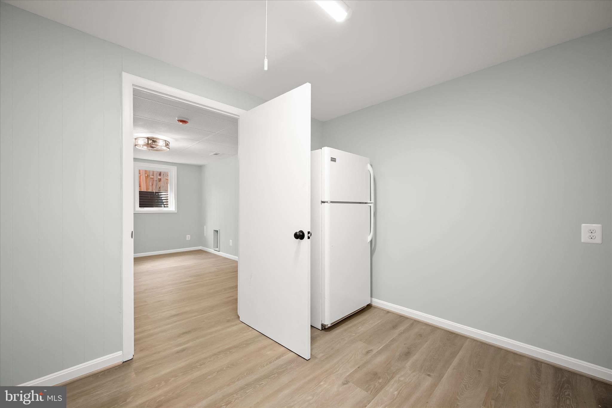 9720 Hedin Drive Silver Spring, MD 20903 - Photo 66 of 79 a view of a hallway with wooden floor and cabinet