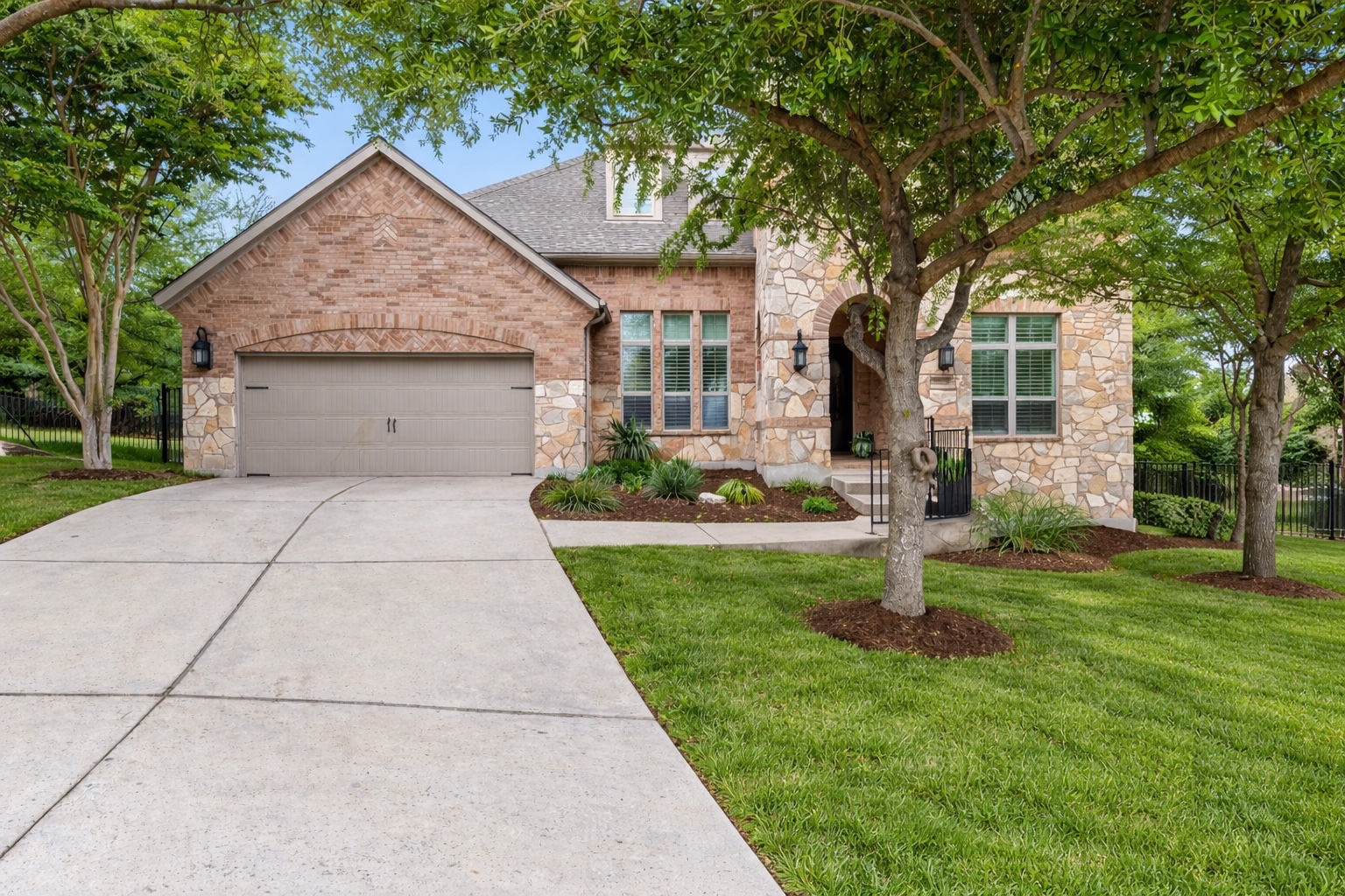 8801 Wild Rice Cove Austin, TX 78738 - Photo 3 of 40 a front view of a house with a yard and trees