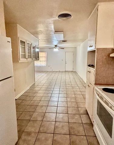 a view of a livingroom with a fireplace and window