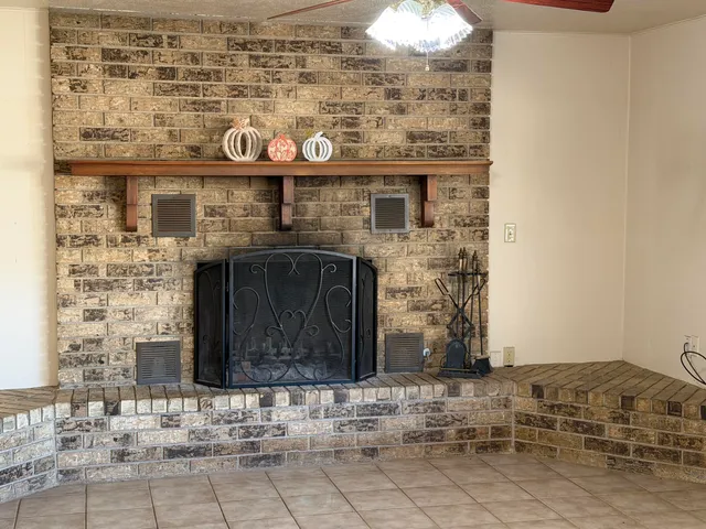a bathroom with a granite countertop sink a toilet a mirror and window