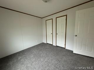 3146 Rte 9W, Unit 5A New Windsor, NY 12553 - Photo 12 of 20 Unfurnished bedroom featuring dark colored carpet and multiple closets
