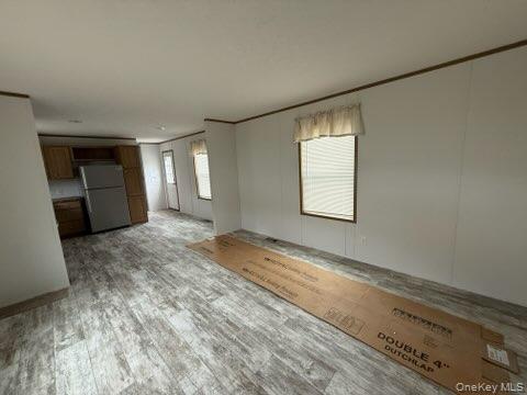 3146 Rte 9W, Unit 5A New Windsor, NY 12553 - Photo 4 of 20 Unfurnished living room with ornamental molding and light wood-style flooring