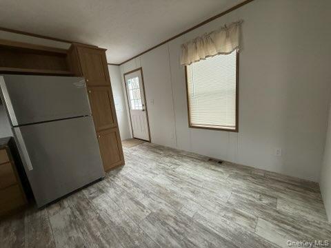 3146 Rte 9W, Unit 5A New Windsor, NY 12553 - Photo 5 of 20 Kitchen with brown cabinets, freestanding refrigerator, and light wood-type flooring